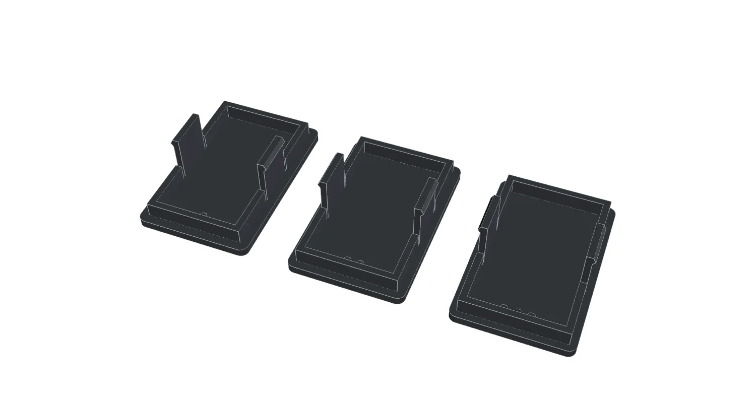 Three dashboard switch blanks on a build plate, clips facing up.